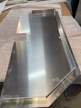 Load image into Gallery viewer, Detail of the lockable metal storage tray designed for under-seat use in a 2022-2024 Toyota Tundra