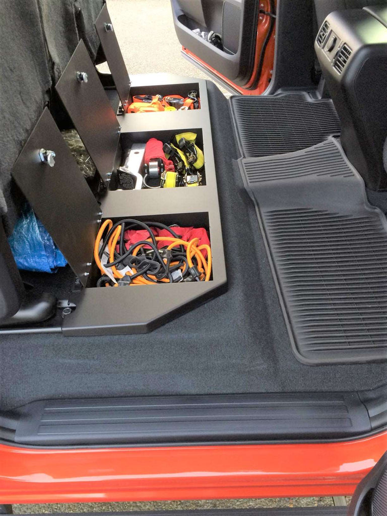 Interior of Toyota Tundra CrewMax showing the under-seat storage with tools arranged inside