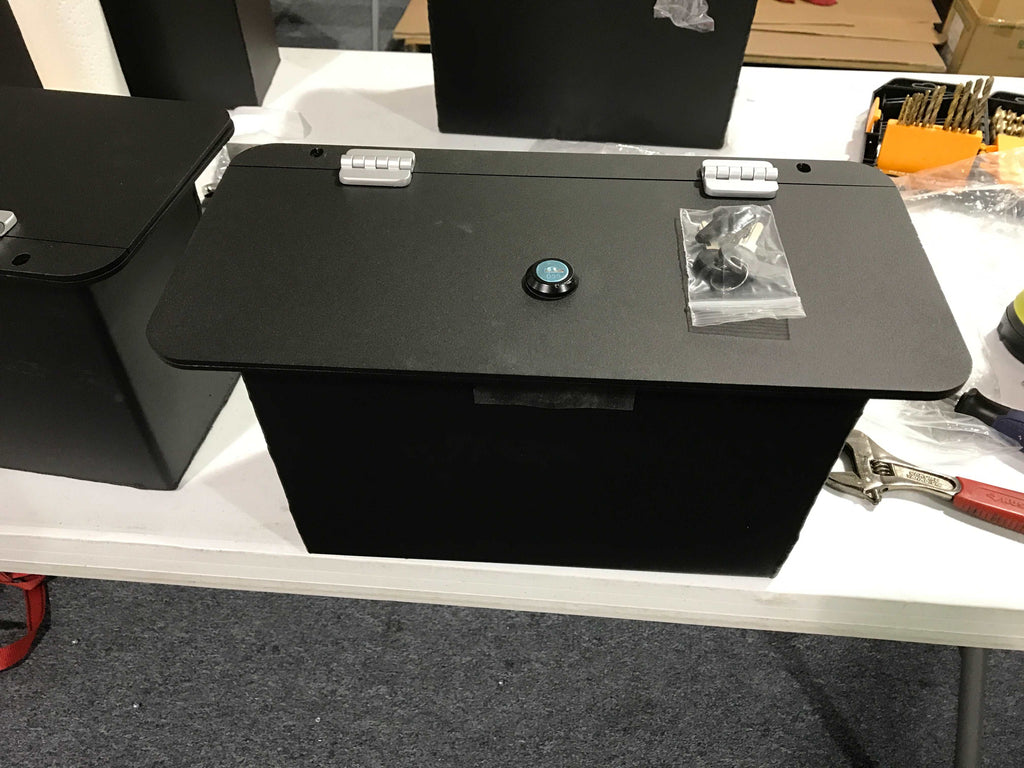 Close-up of the locking mechanism on the Dodge RAM floor box with a key inserted