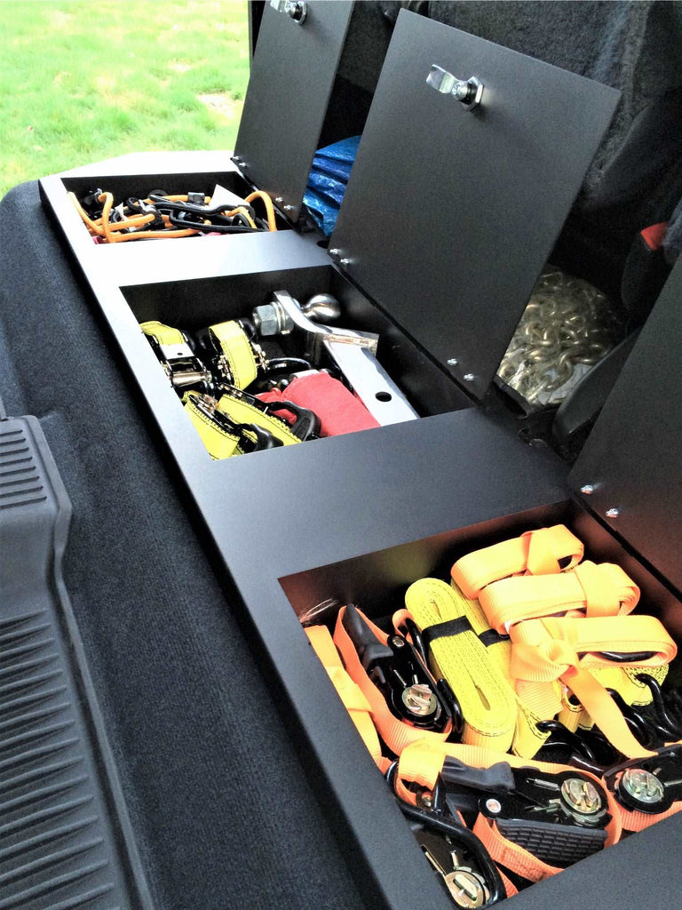 Cargo area of Toyota Tundra CrewMax featuring under-seat storage with various items