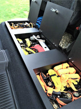 Load image into Gallery viewer, Cargo area of Toyota Tundra CrewMax featuring under-seat storage with various items