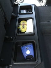 Load image into Gallery viewer, Tundra model rear seat upgrade with a compartment holding a yellow and blue toolbox