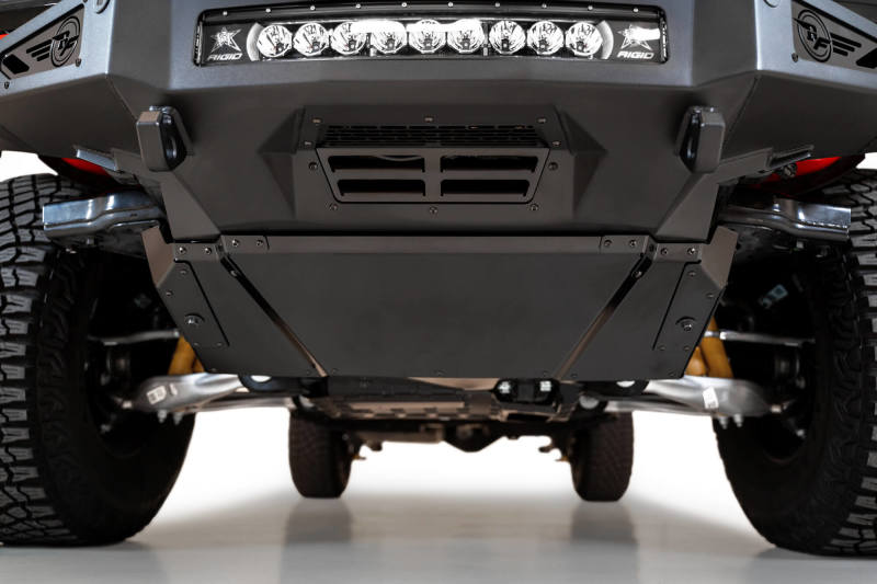 Black ATV equipped with Addictive Desert Designs Rock Fighter Skid Plate and additional light bar