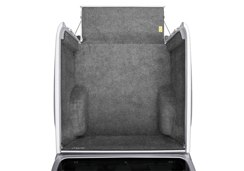 Open trunk of a Nissan vehicle displaying the gray BedRug protection