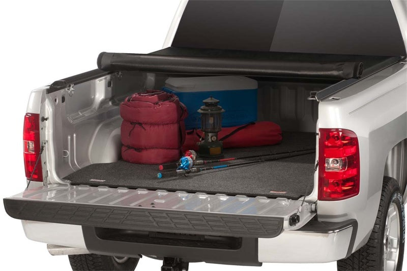 The Access Limited roll-up cover neatly stowed in a truck bed alongside outdoor gear