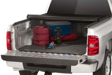Load image into Gallery viewer, The Access Limited roll-up cover neatly stowed in a truck bed alongside outdoor gear