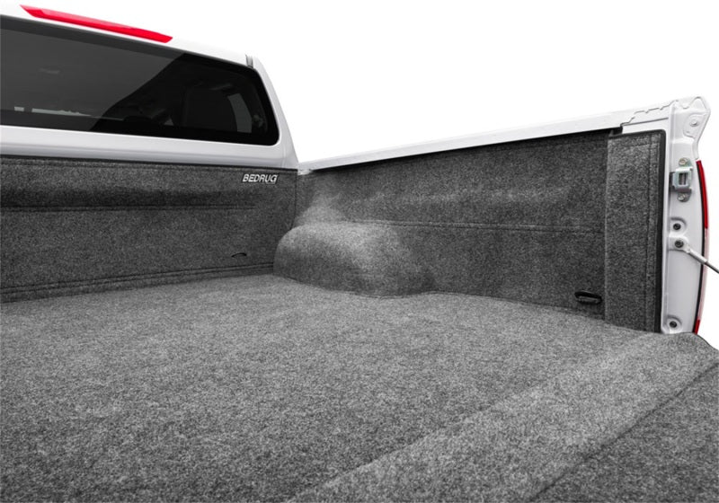 Folded down seat in a Nissan car showing the BedRug liner beneath