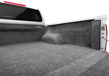 Load image into Gallery viewer, Folded down seat in a Nissan car showing the BedRug liner beneath