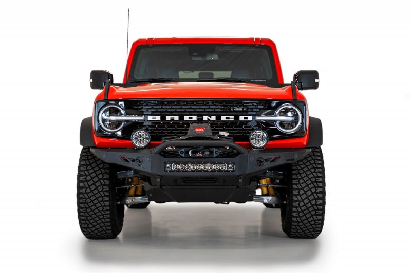 Detailed view of the Addictive Desert Designs Rock Fighter Skid Plate on a red Ford Bronco