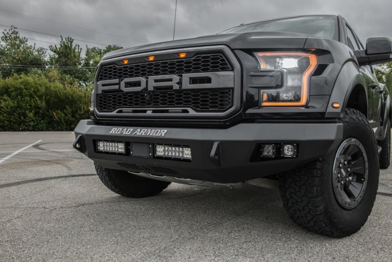 The front of a black Ford Raptor with a Road Armor 17-20 Ford Raptor Stealth Front Non-Winch Bumper - Tex Blk.