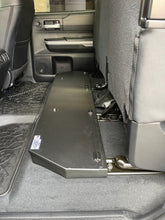 Load image into Gallery viewer, Rear seat of Toyota Tundra CrewMax equipped with under seat storage and foldable tray