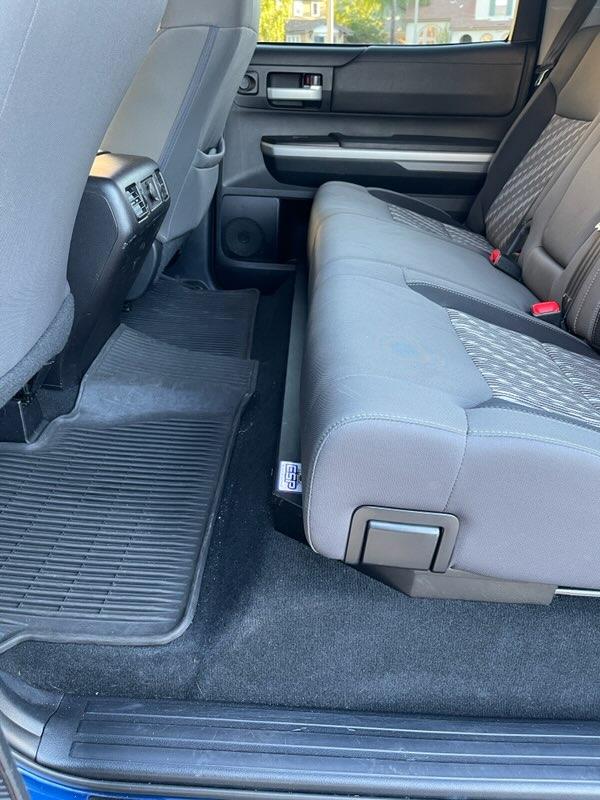 Custom-fit under seat storage in a Toyota Tundra CrewMax with blue interior lining