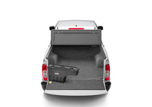 Load image into Gallery viewer, Cargo bed of a white Nissan Frontier equipped with a BedRug liner