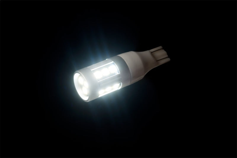 Illuminated Putco 921 White Metal 360 LED bulb in a dark setting