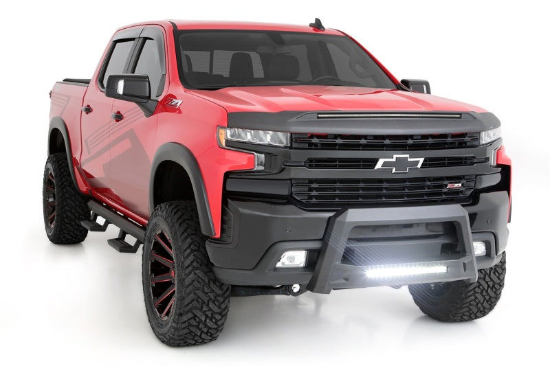 Red Chevrolet Silverado 1500 featuring Lund Revolution Bull Bar, front angle view