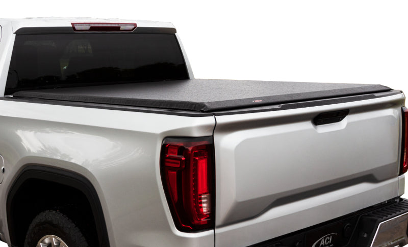 Rear view of a white truck equipped with the Access Limited black roll-up cover
