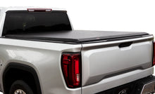 Load image into Gallery viewer, Rear view of a white truck equipped with the Access Limited black roll-up cover