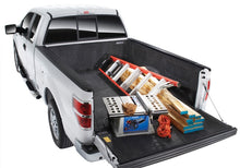 Load image into Gallery viewer, Nissan truck bed with a BedRug liner and an added toolbox