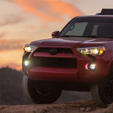 Load image into Gallery viewer, White Rigid Industries 360-Series PRO SAE Fog Lights mounted on a Toyota 4Runner